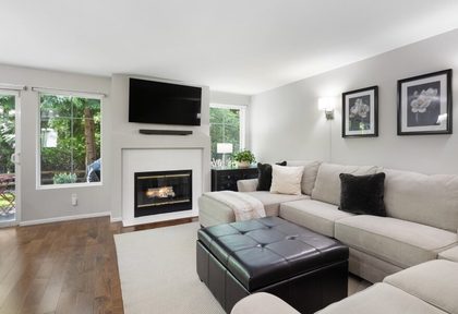 Prepared living room with fireplace and natural light.