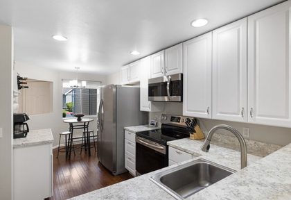 Bright kitchen with white cabinetry and updated counters.